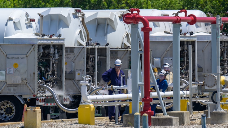 Technician supervising Linde tanker trucks delivering liquid hydrogen into pipe network at NASA’s Kennedy Space Center.