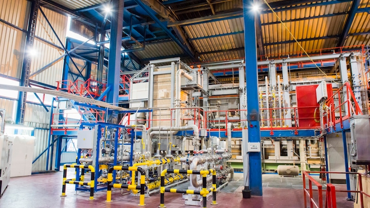 Large industrial equipment on factory floor of glass manufacturer